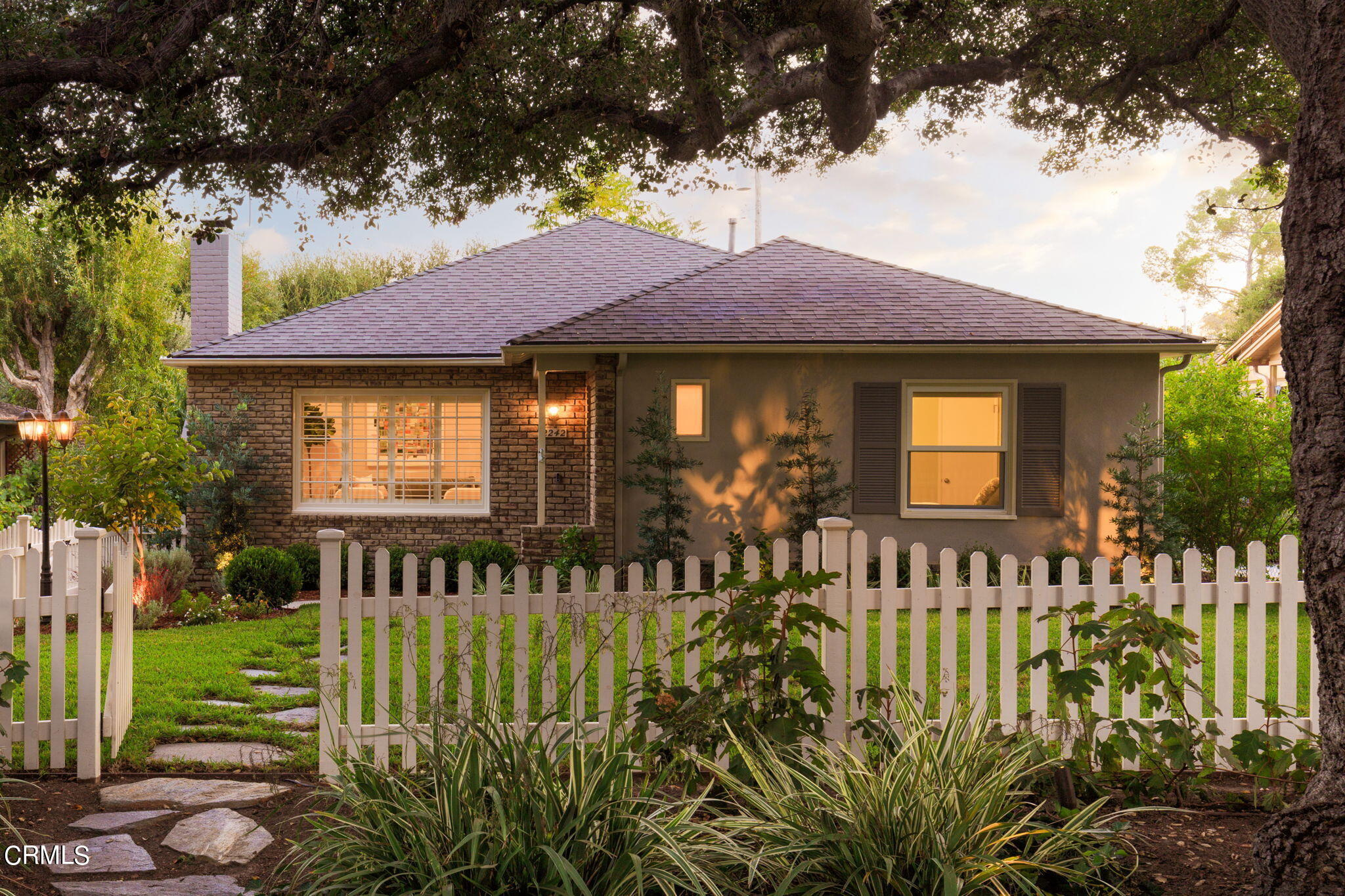 a front view of a house with a garden