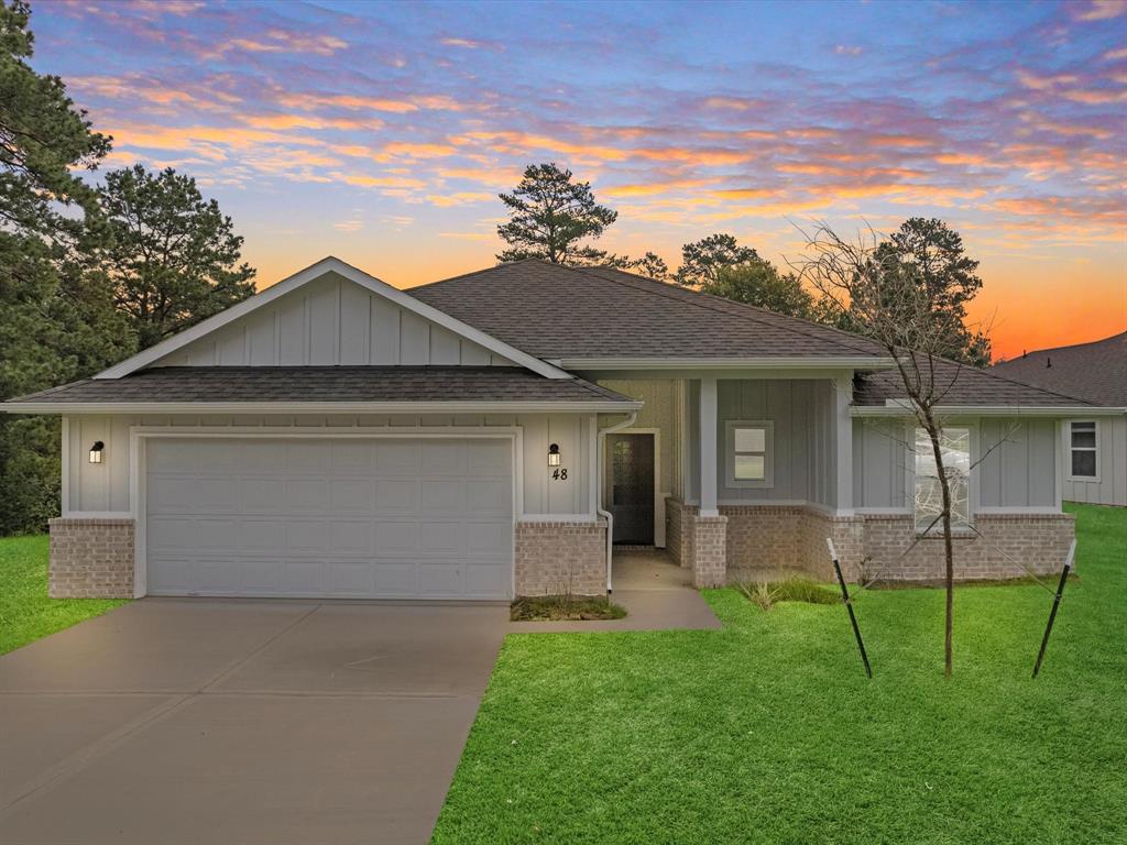 a front view of house with yard and green space