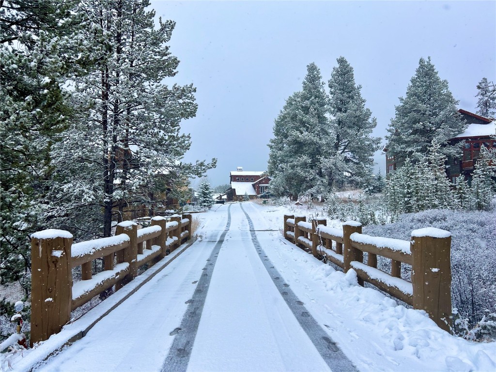 a view of deck with furniture and trees