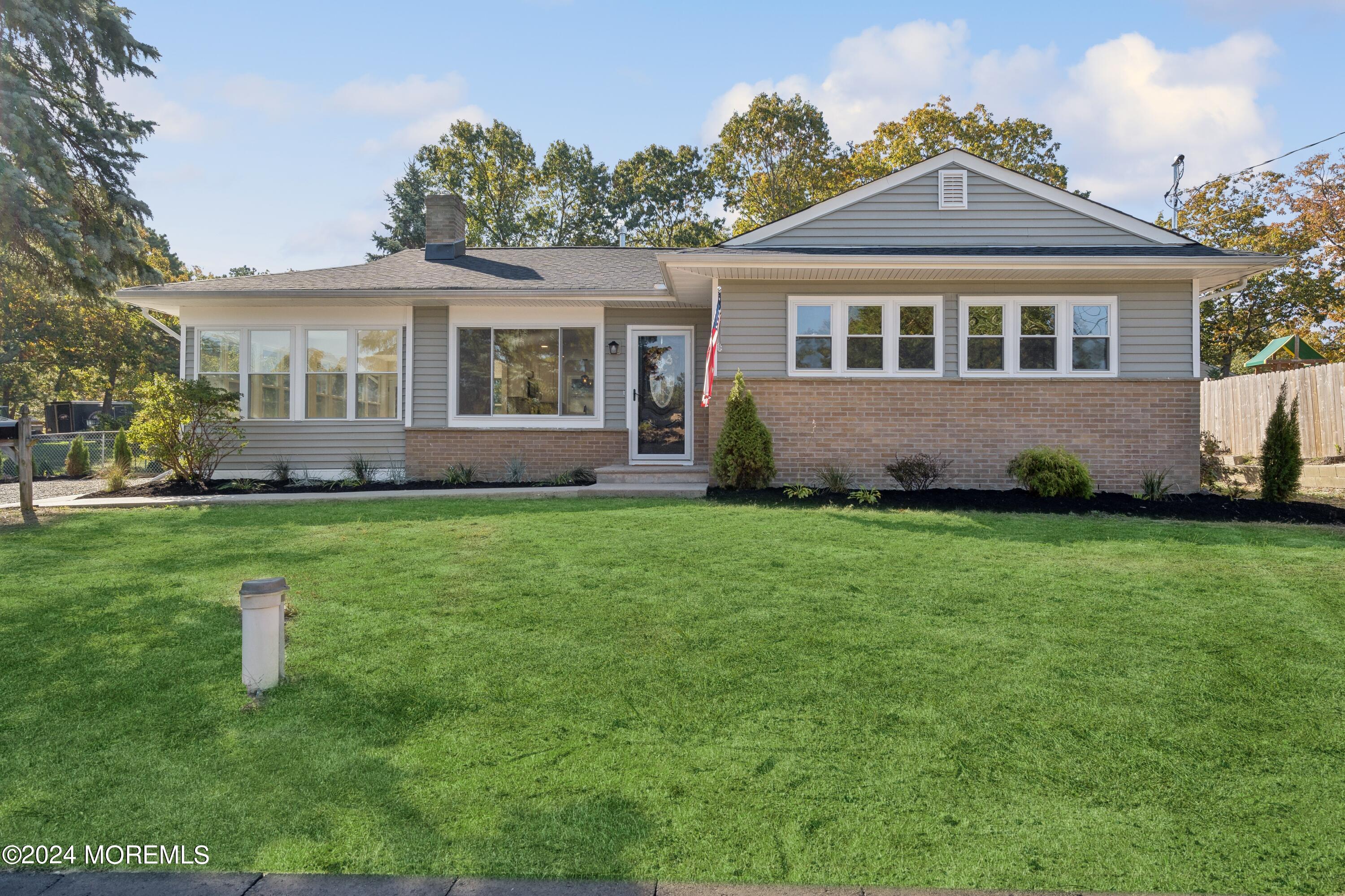 a front view of a house with a garden