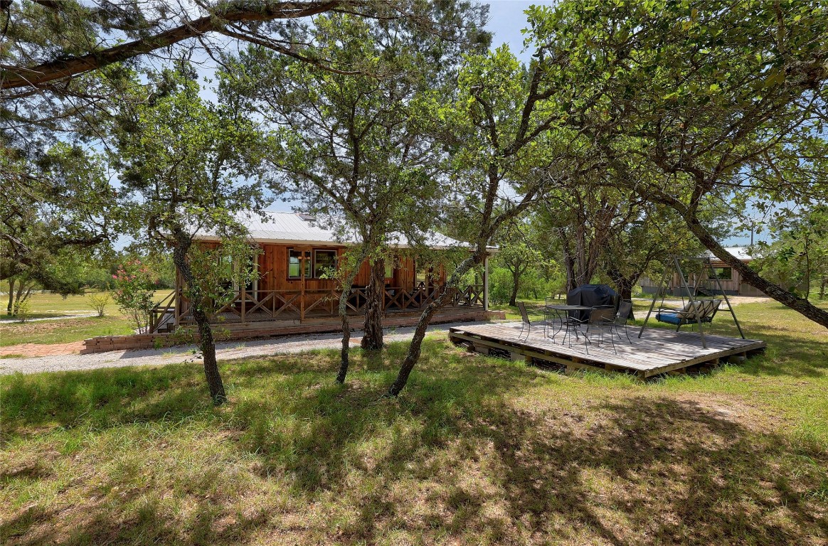 a view of a house with swimming pool and sitting area