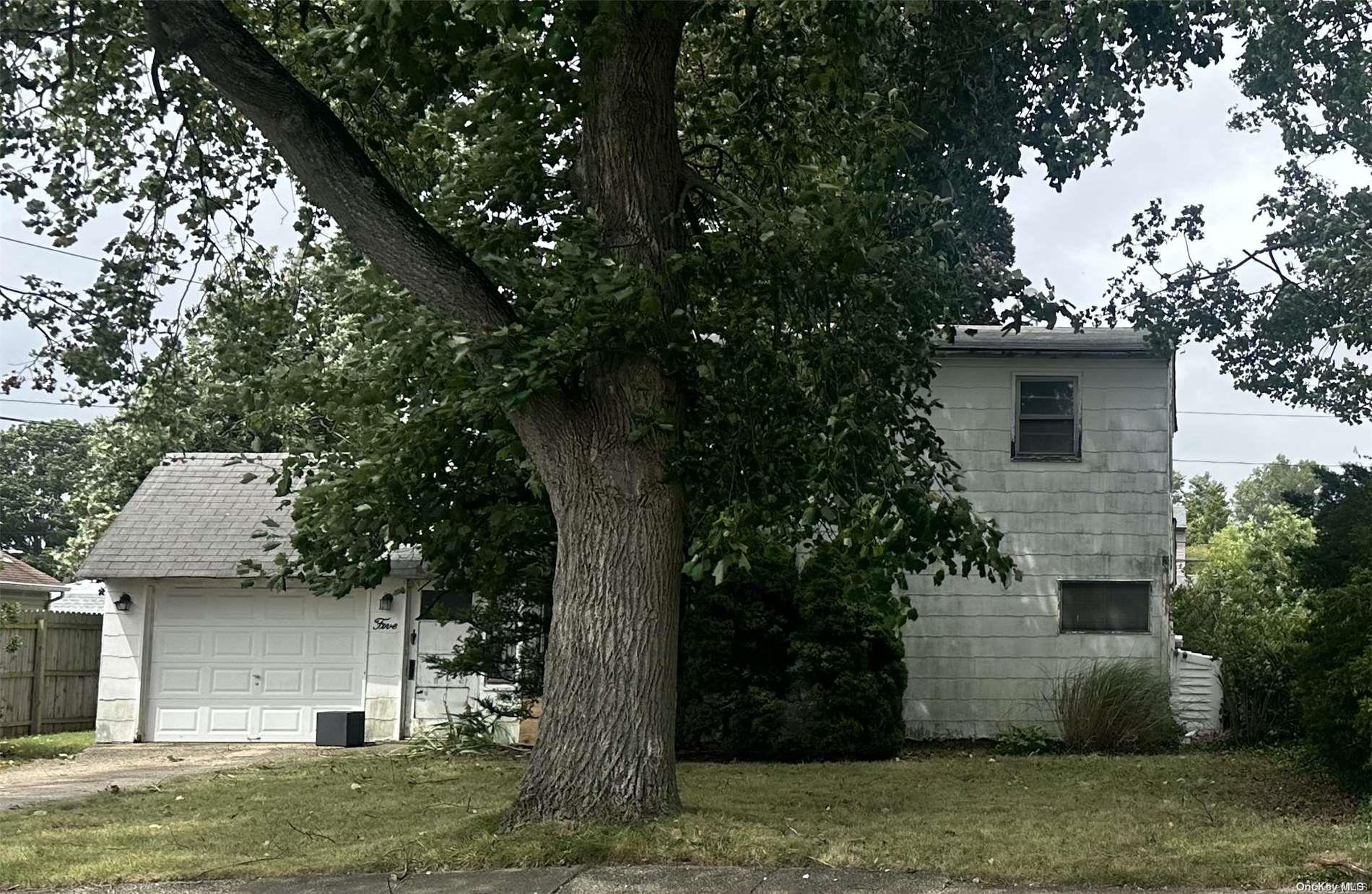 a view of a house with a tree