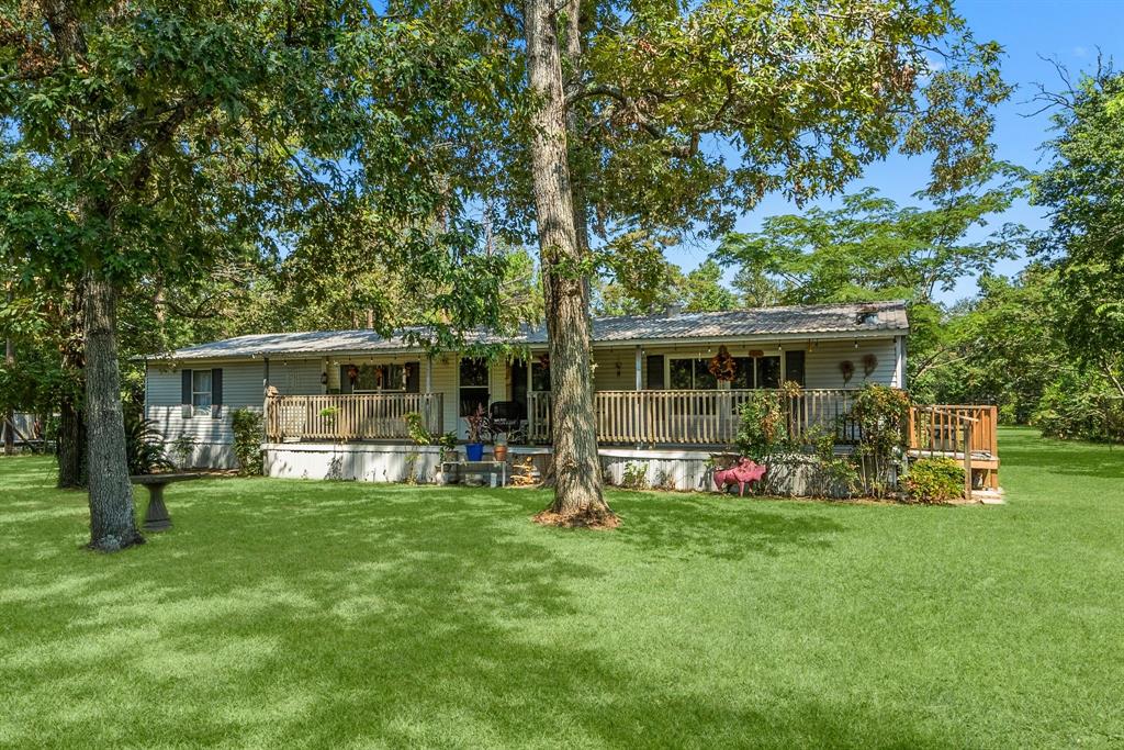 a front view of house with yard seating and green space