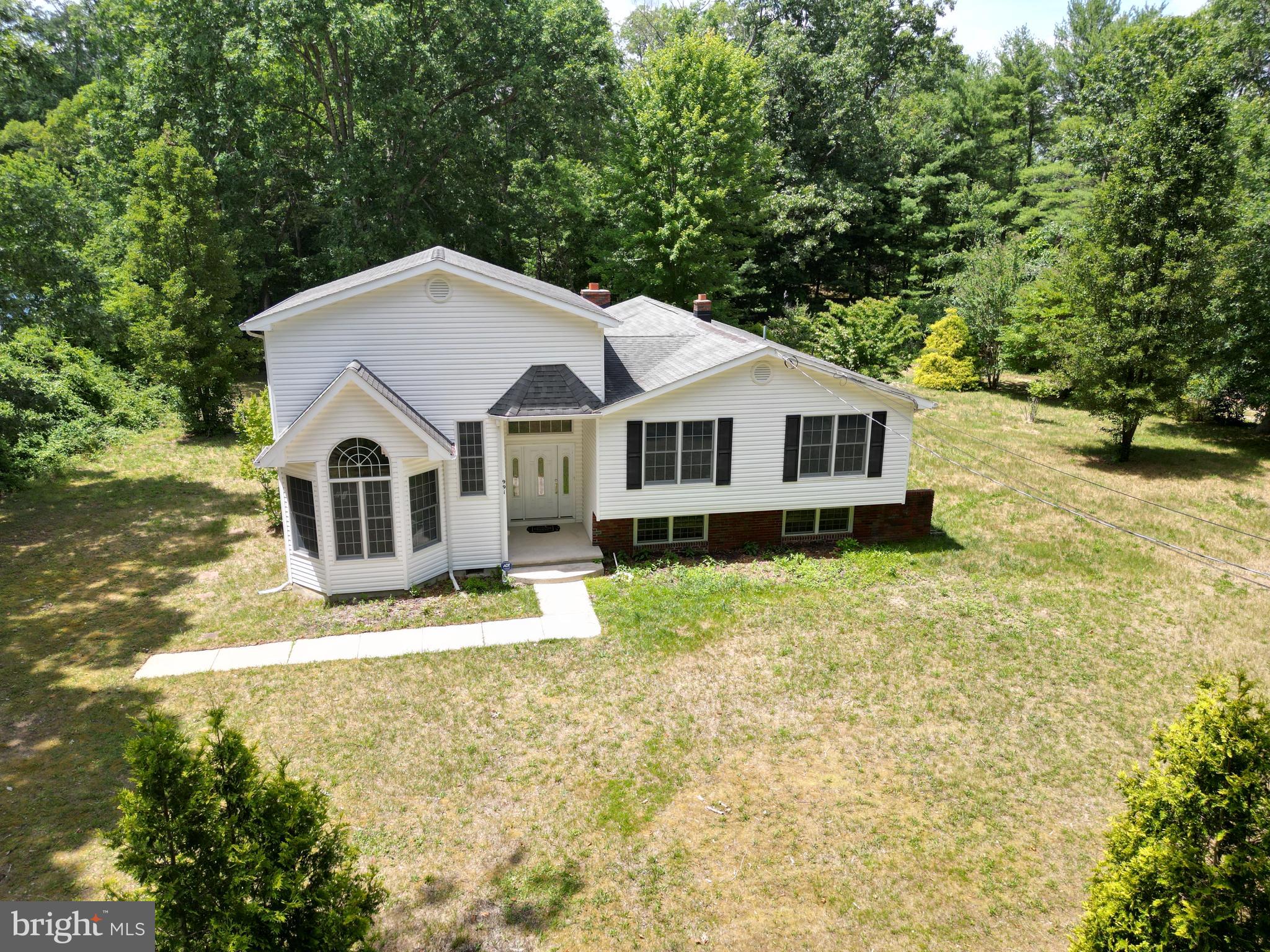 a view of a house with a yard and sitting area