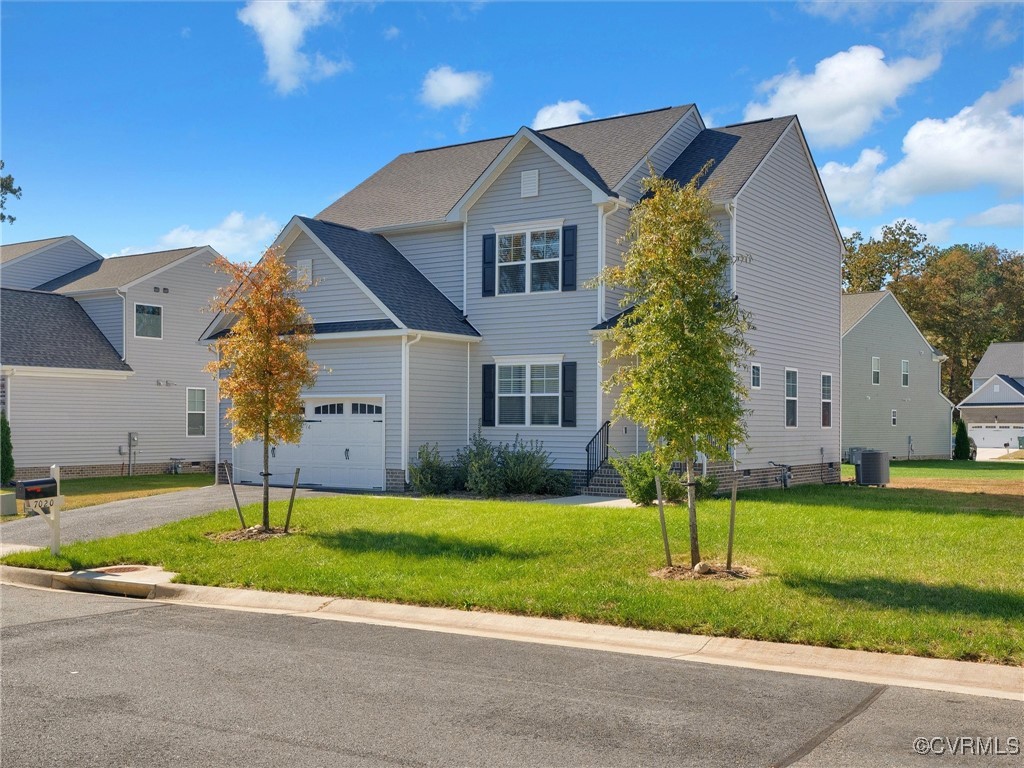 a front view of a house with a yard and garage