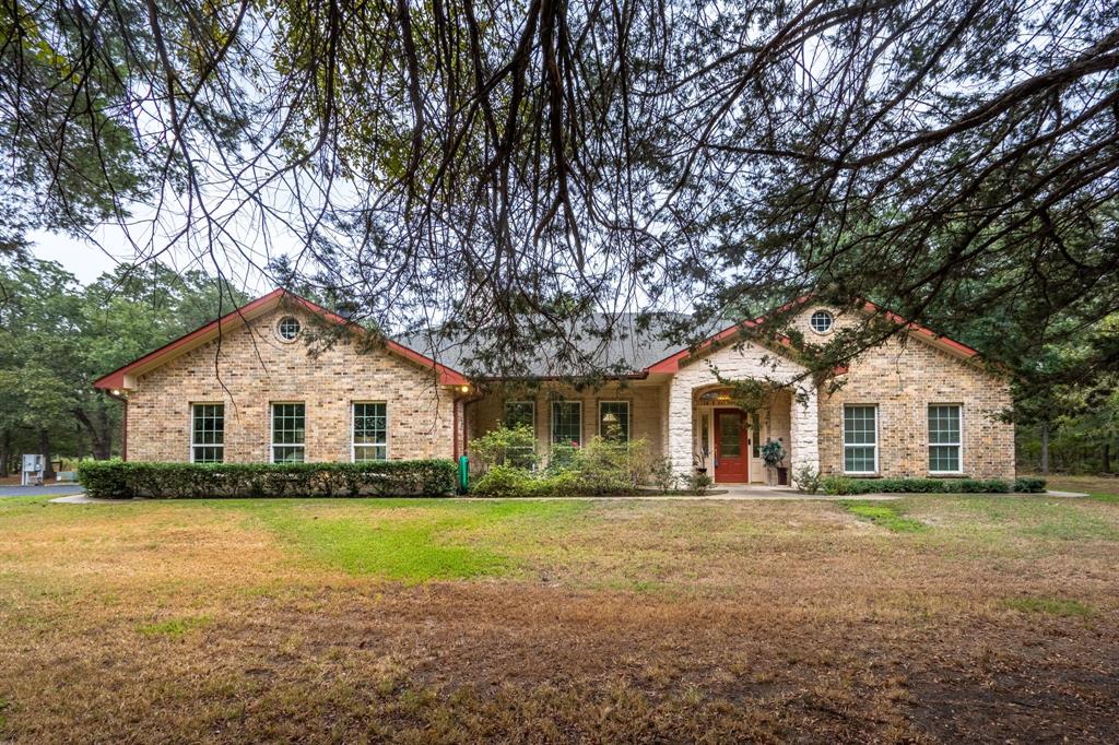 a front view of house with yard and green space