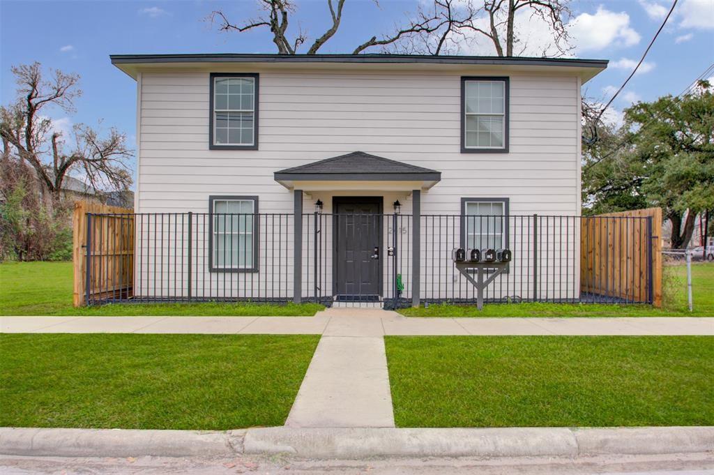 a front view of a house with a garden and yard