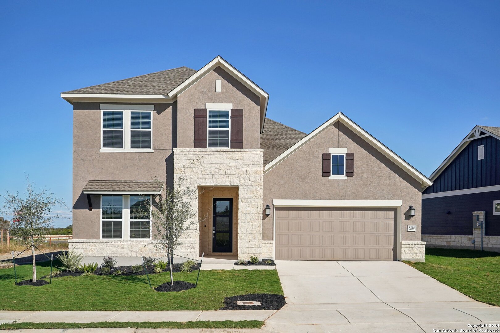 a front view of a house with a yard