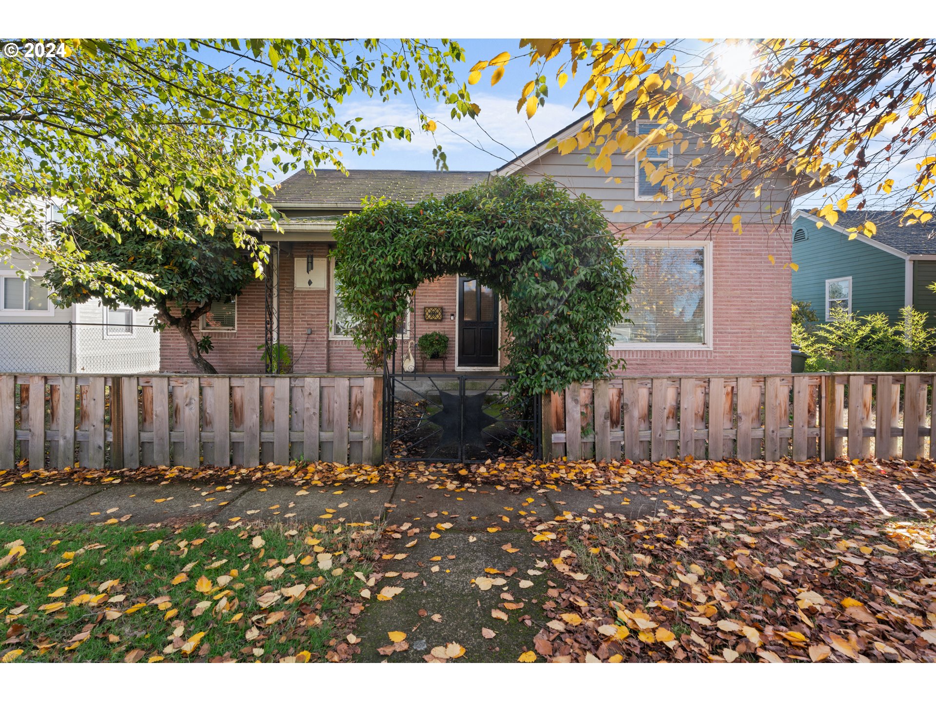 a view of a house with a wooden fence