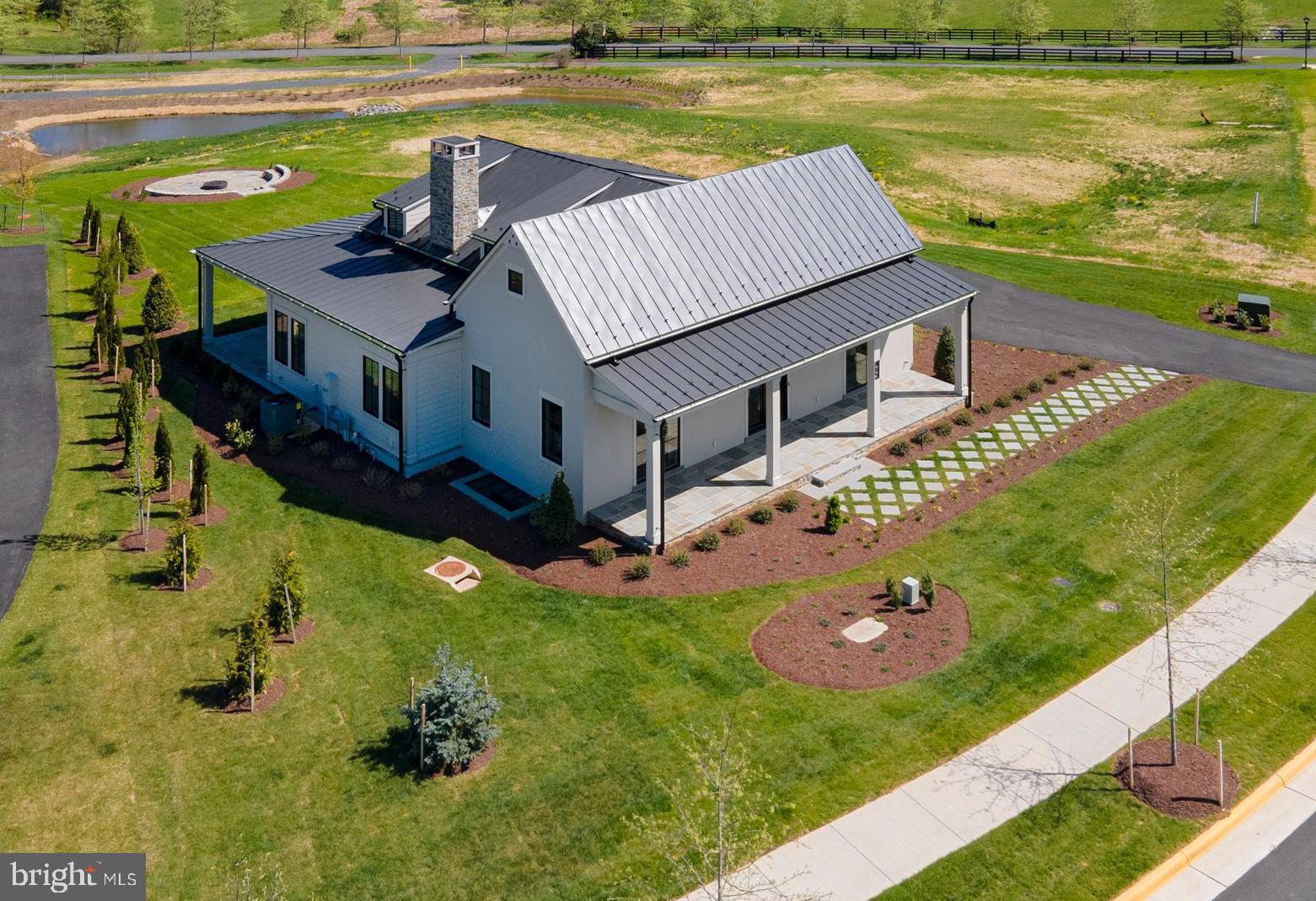 a view of a house with pool and a yard