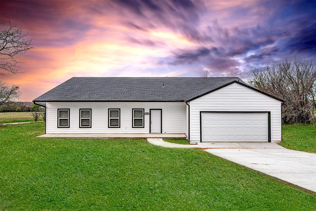 a front view of house with yard and green space