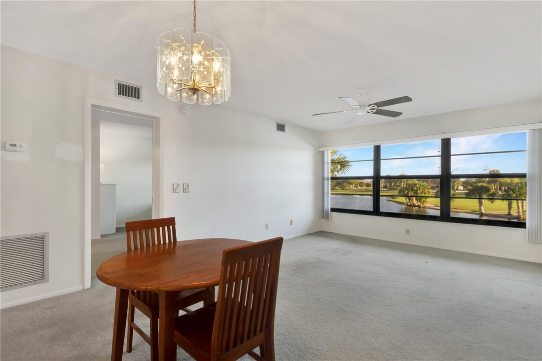 a view of a room with lots of furniture wooden floor and a chandelier