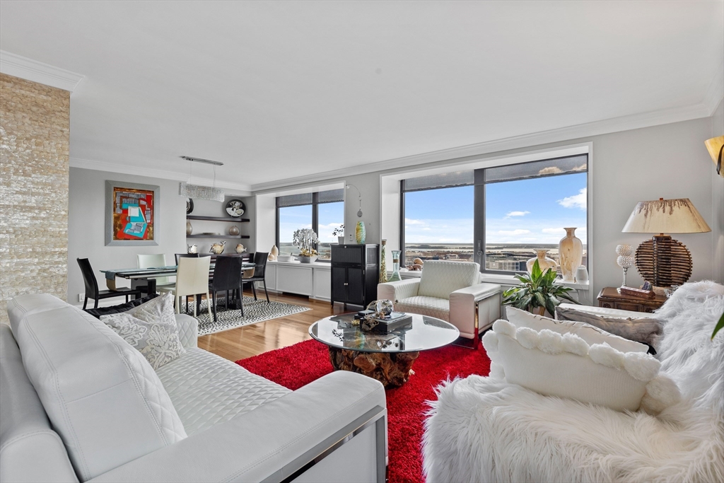 a living room with furniture large windows and a flat screen tv