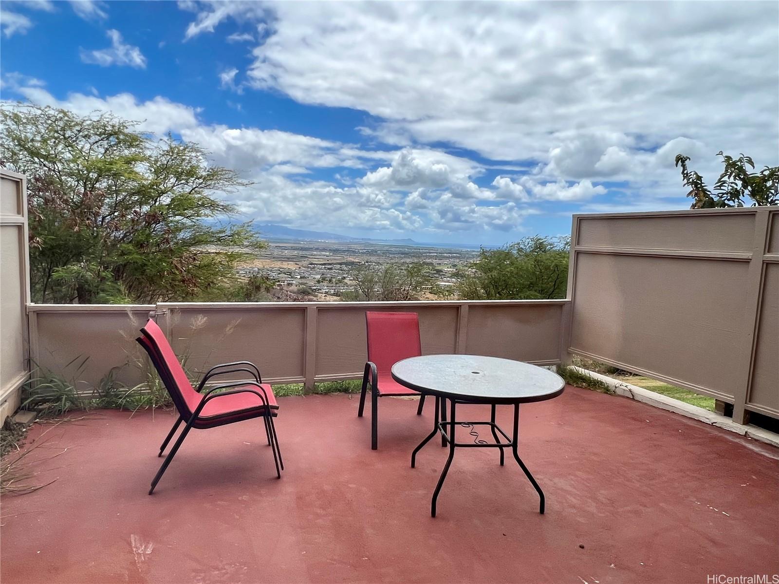 a view of a chairs and table in the backyard