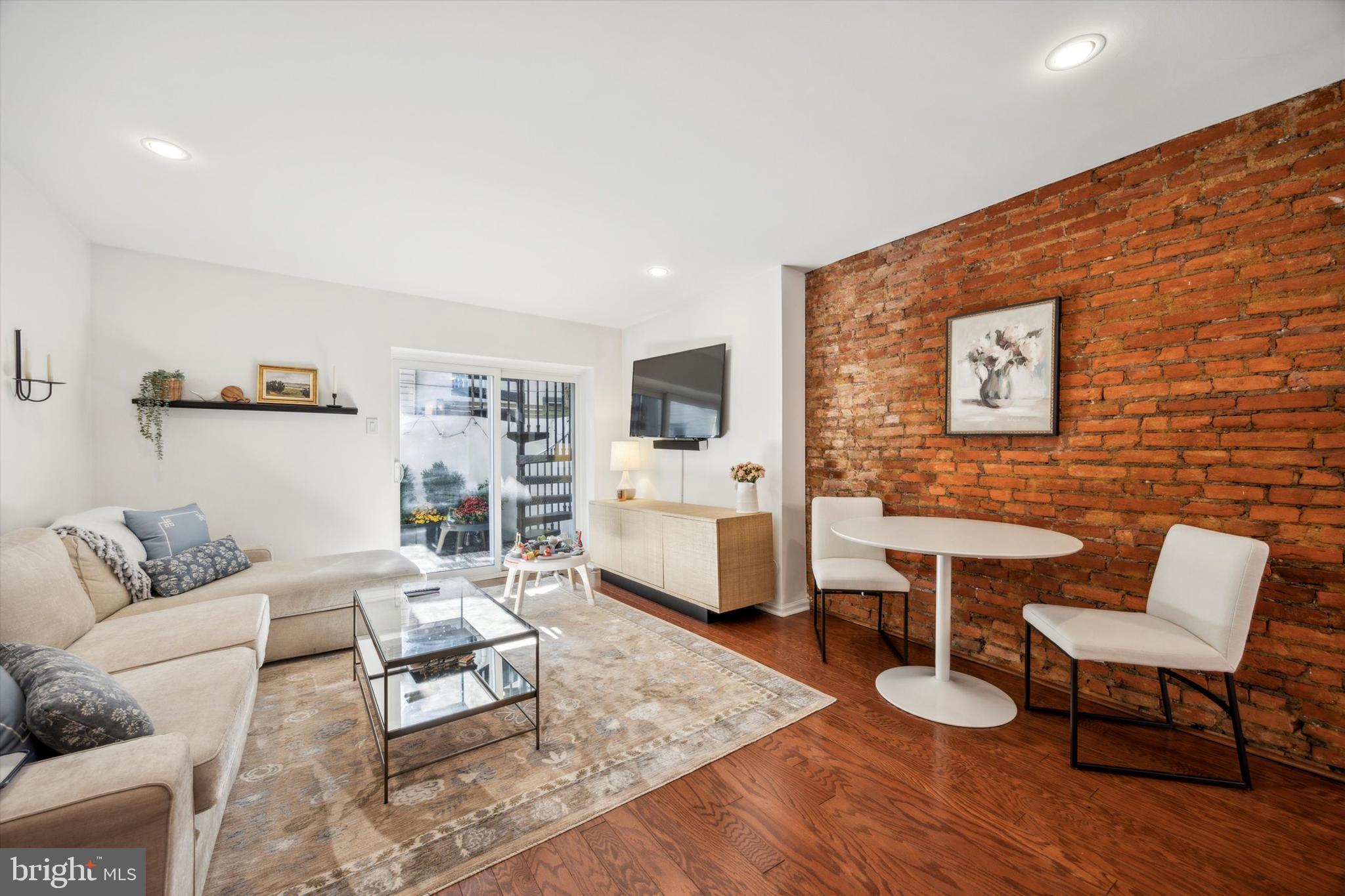 a living room with furniture a rug and a wooden floor