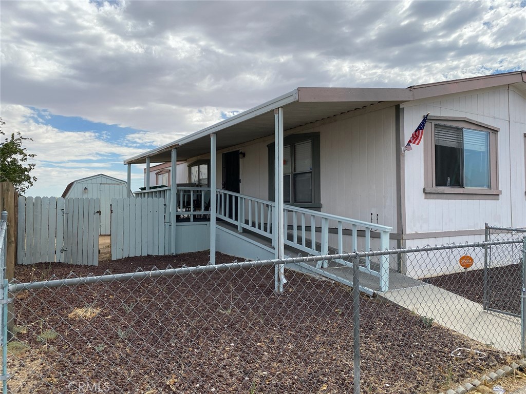 a view of a house with wooden fence