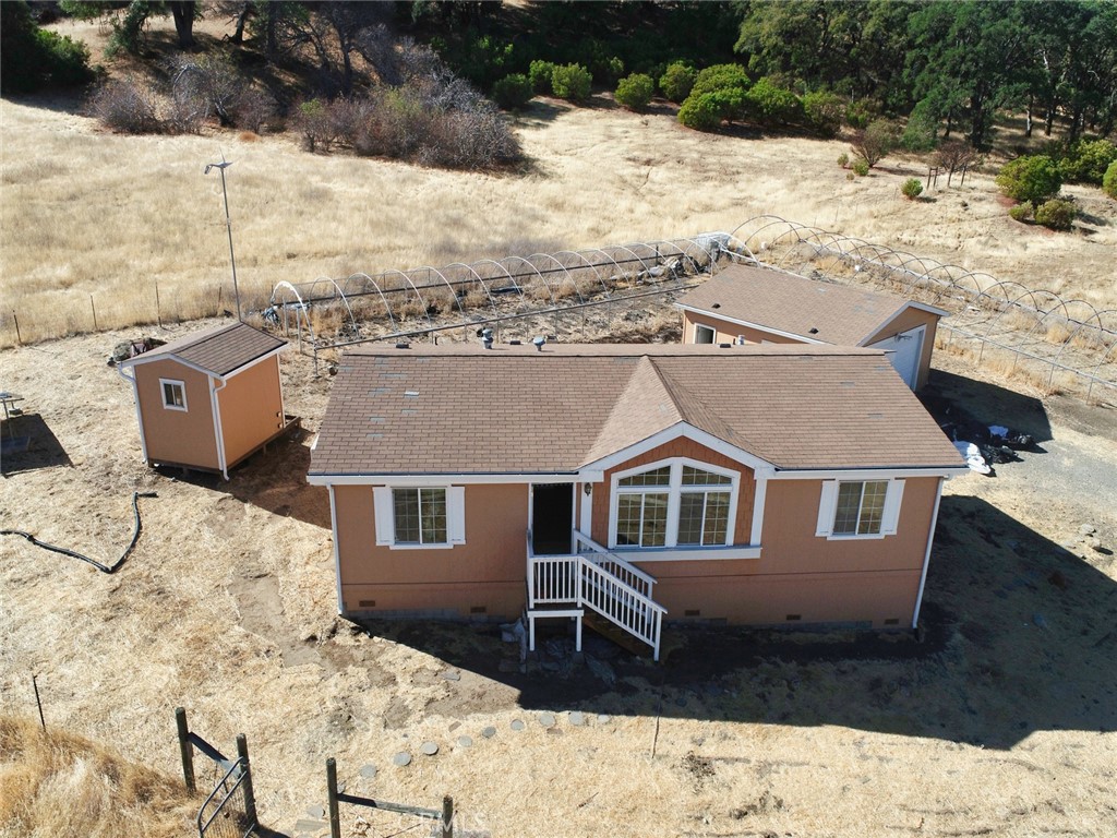 a aerial view of a house with a yard covered in snow