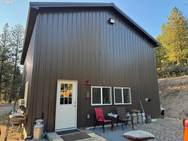 a front view of a house with outdoor seating