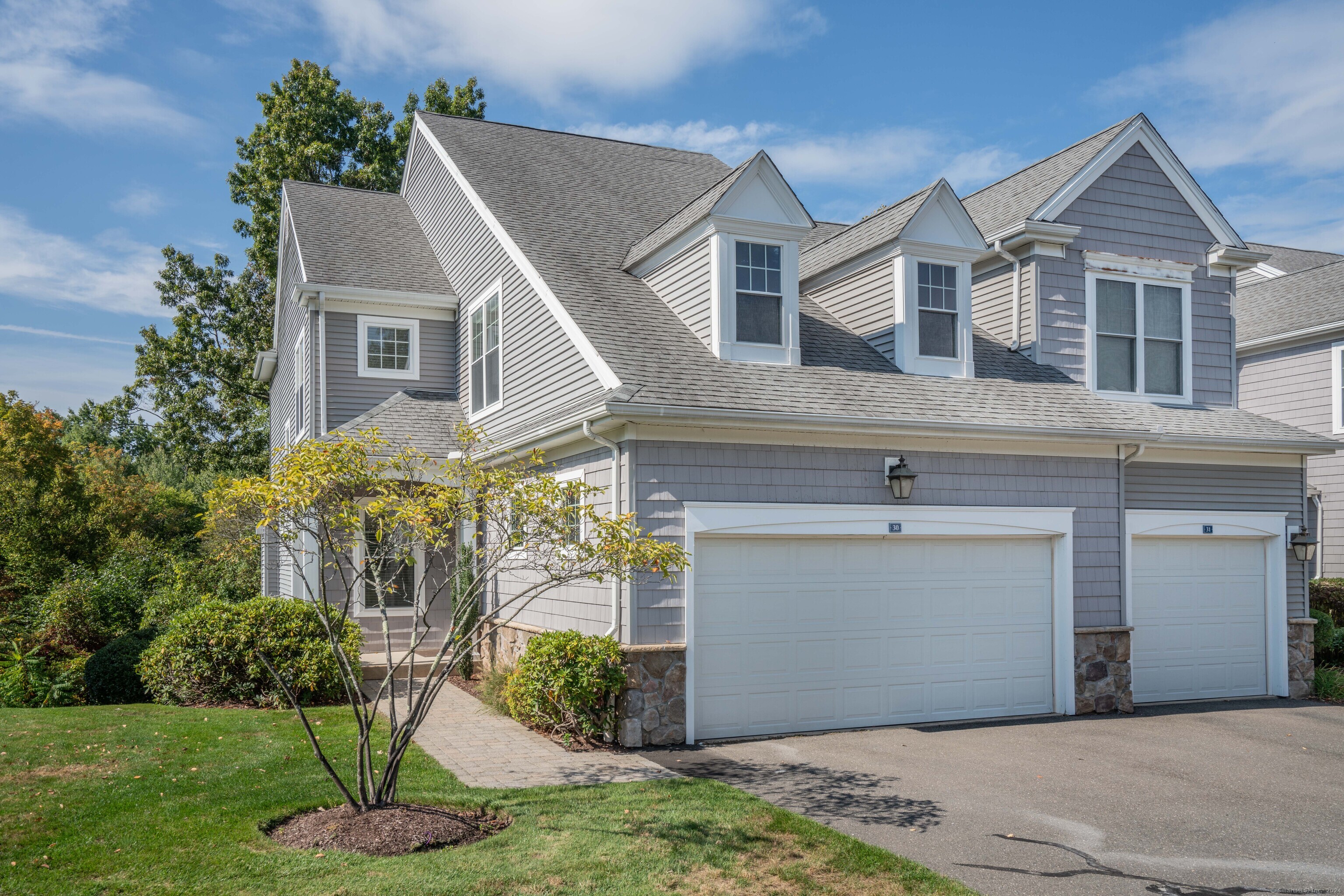 a front view of a house with a yard and garage