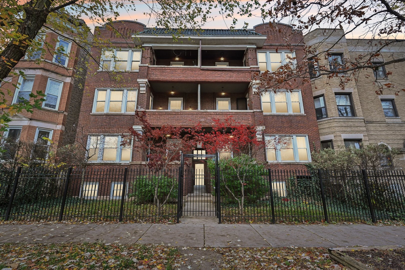 a front view of a residential apartment building with a yard