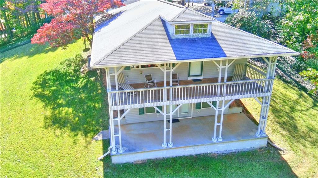 a view of house with outdoor seating yard and deck