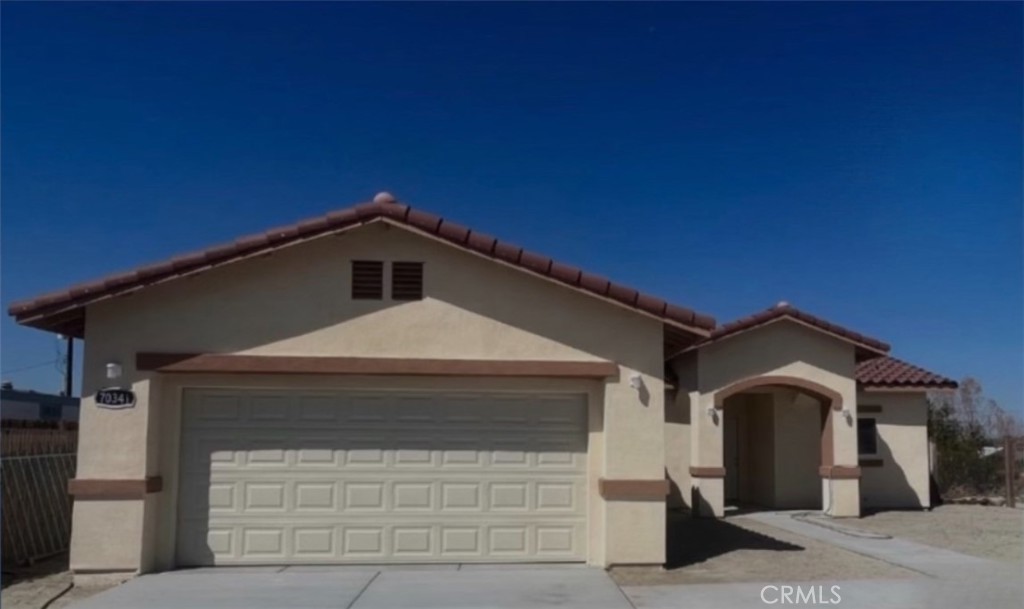 a front view of a house with garage