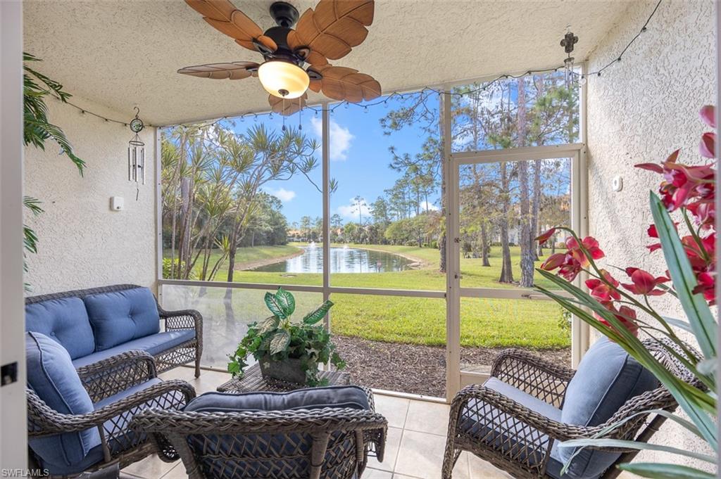 a living room with patio furniture and a floor to ceiling window