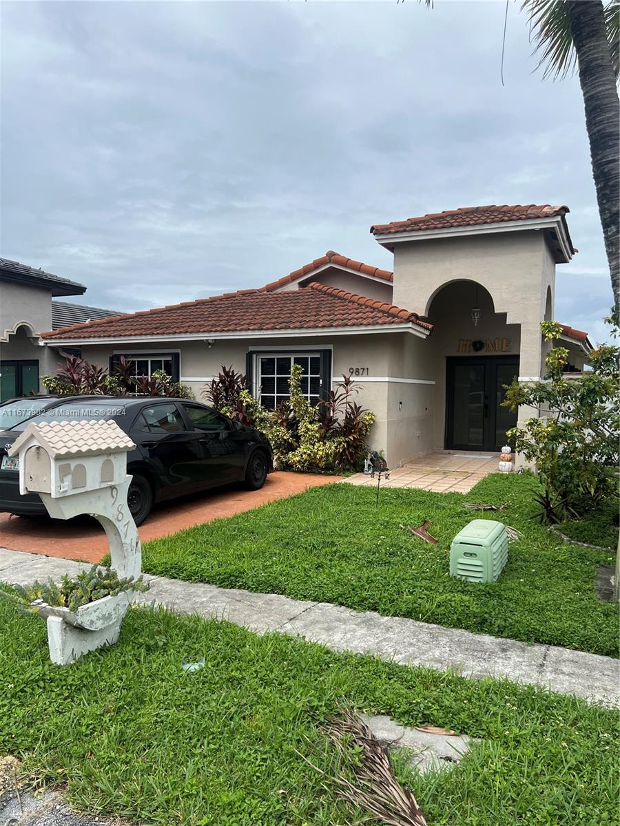 a front view of a house with garden