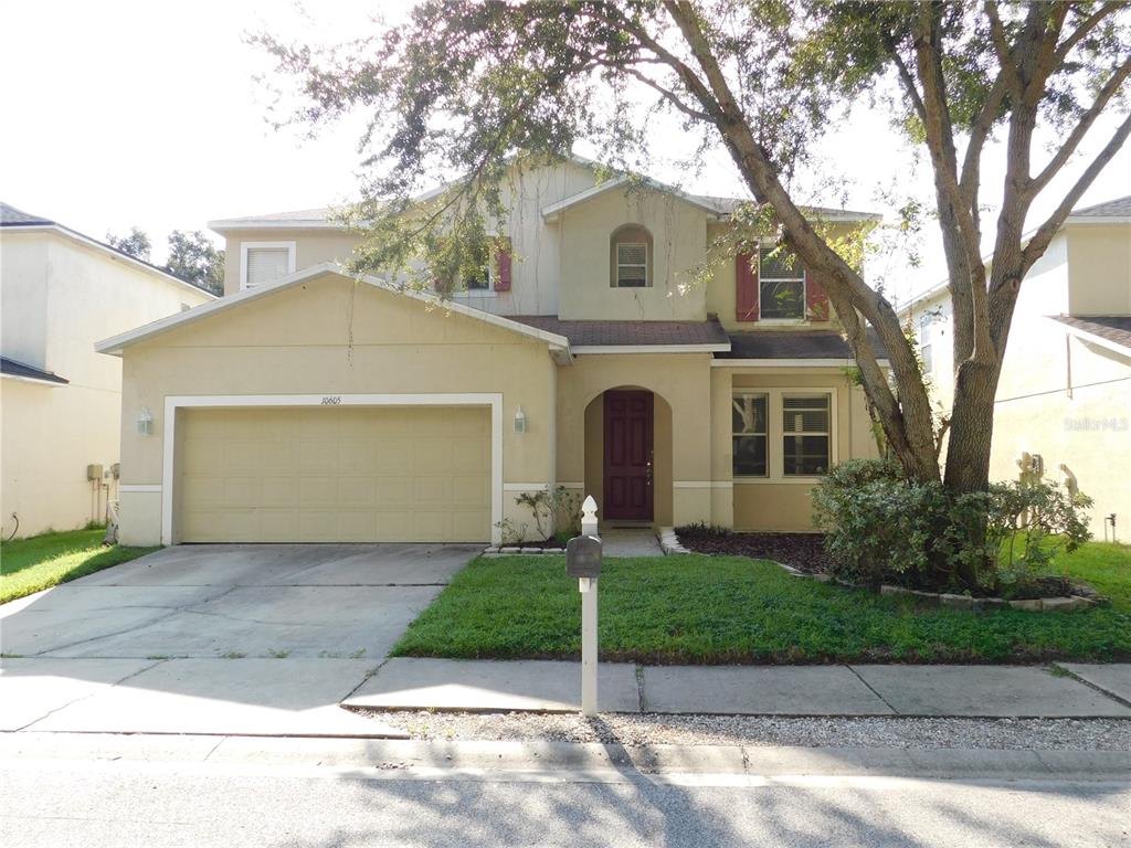 a front view of a house with a yard and garage