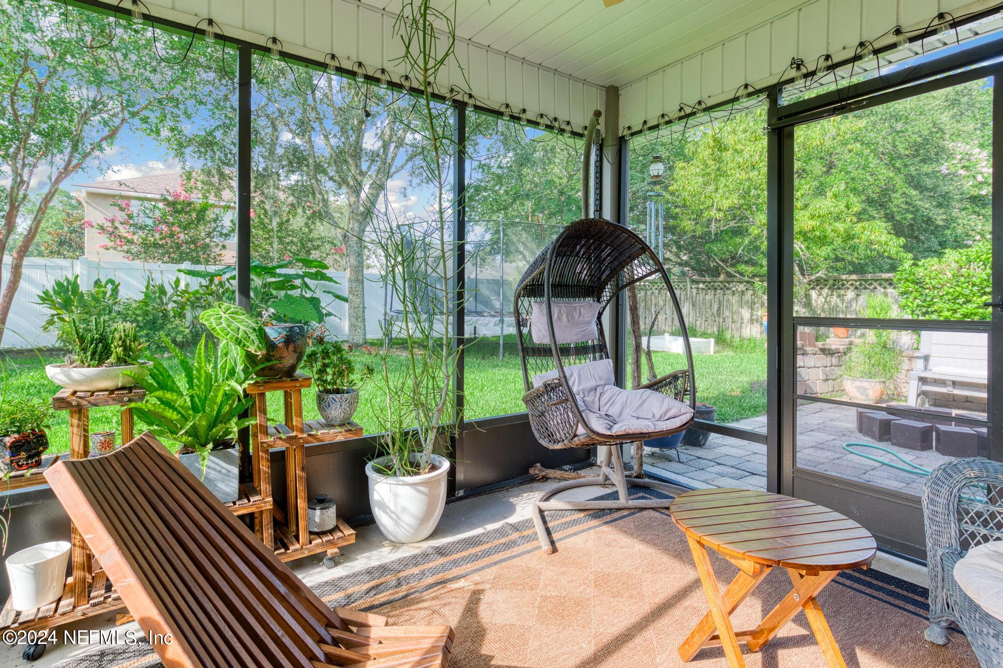 a view of an outdoor sitting area with furniture and garden view