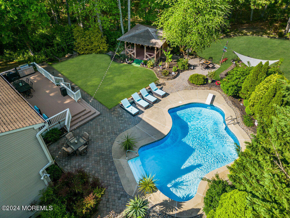 an aerial view of a house yard swimming pool and outdoor seating