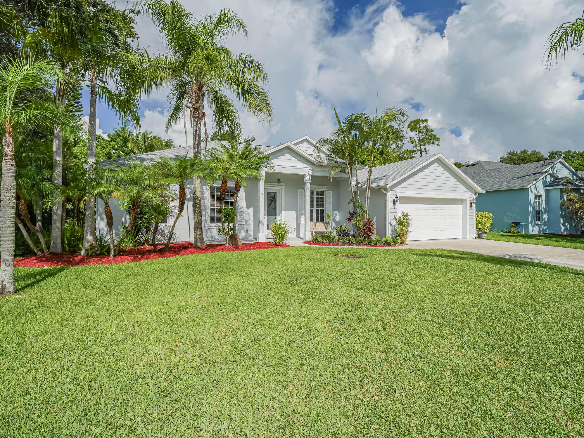 a front view of house with yard and green space