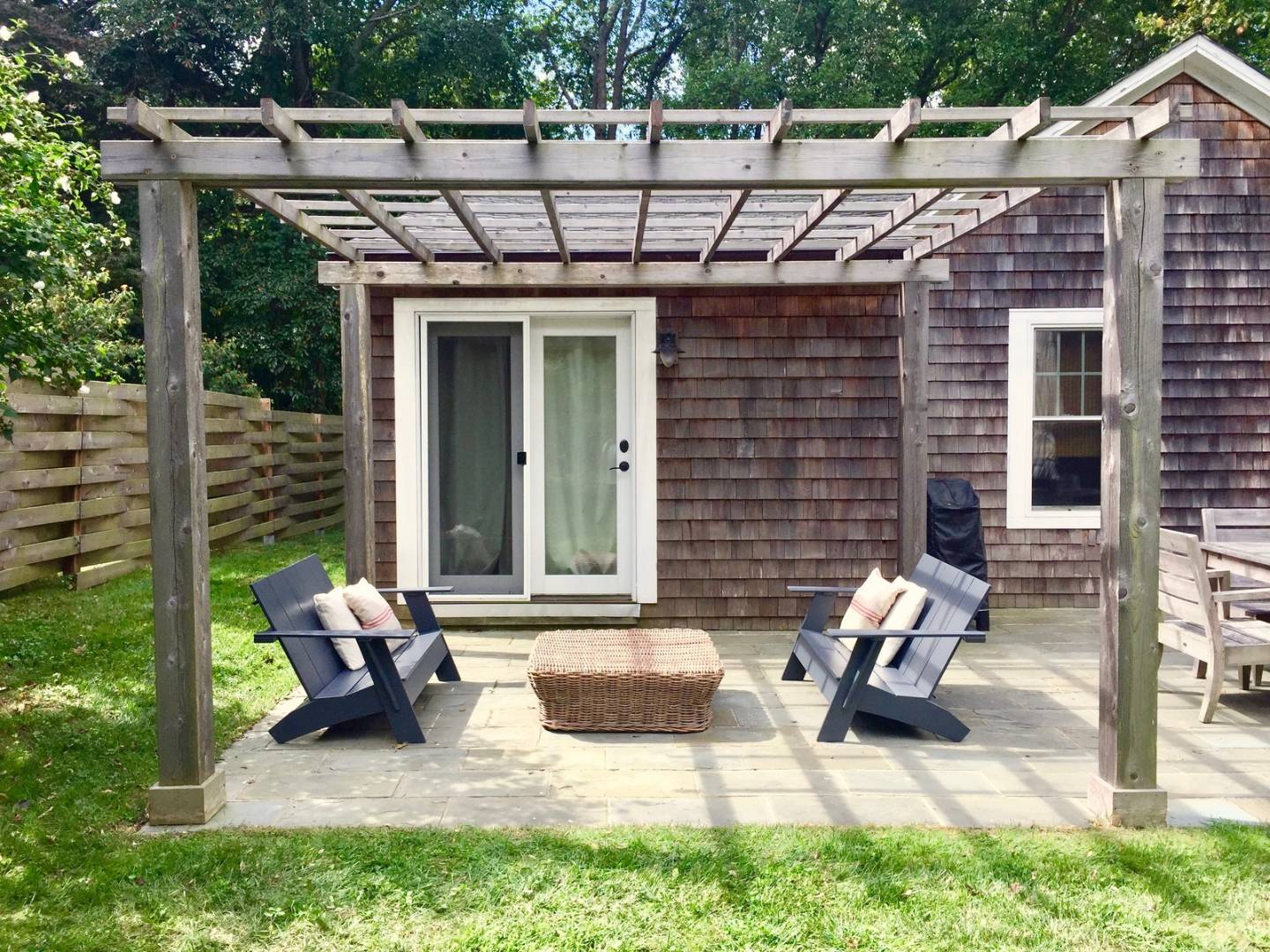 a view of a patio with table and chairs and potted plants