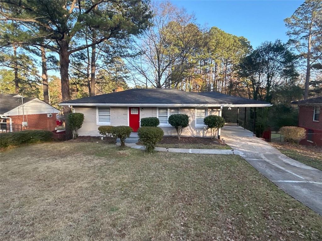 a view of a house with a yard and tree s