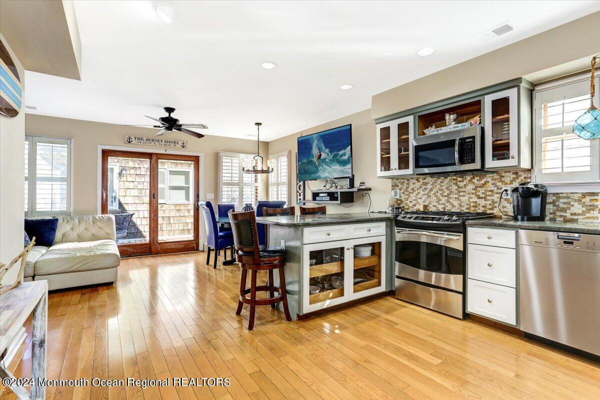 a kitchen with stainless steel appliances granite countertop a stove and a sink