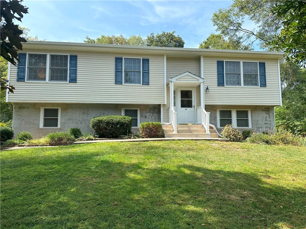 Bi-level home featuring a front lawn