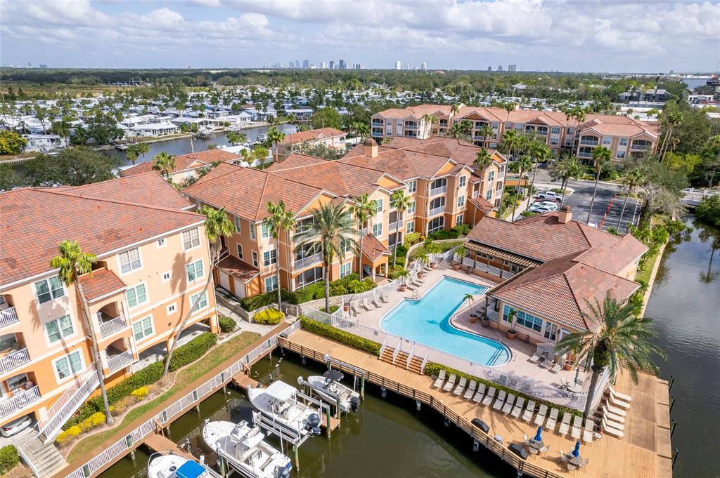 an aerial view of residential houses with outdoor space and swimming pool