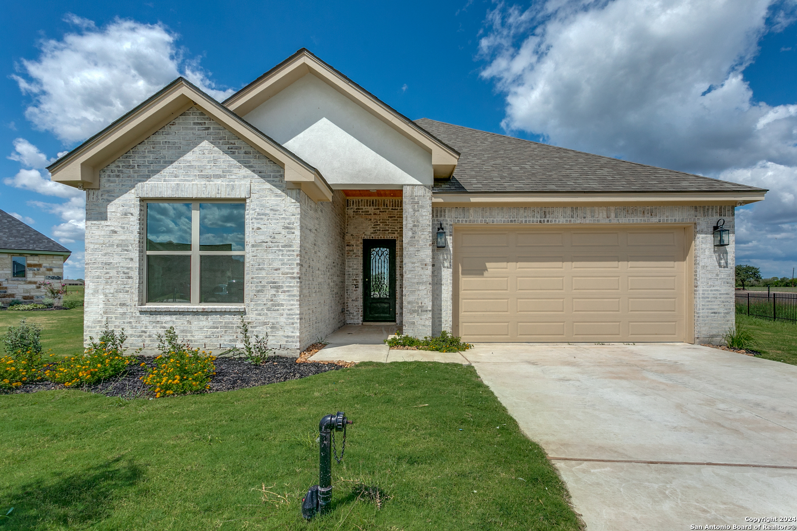 a front view of a house with a yard and garage