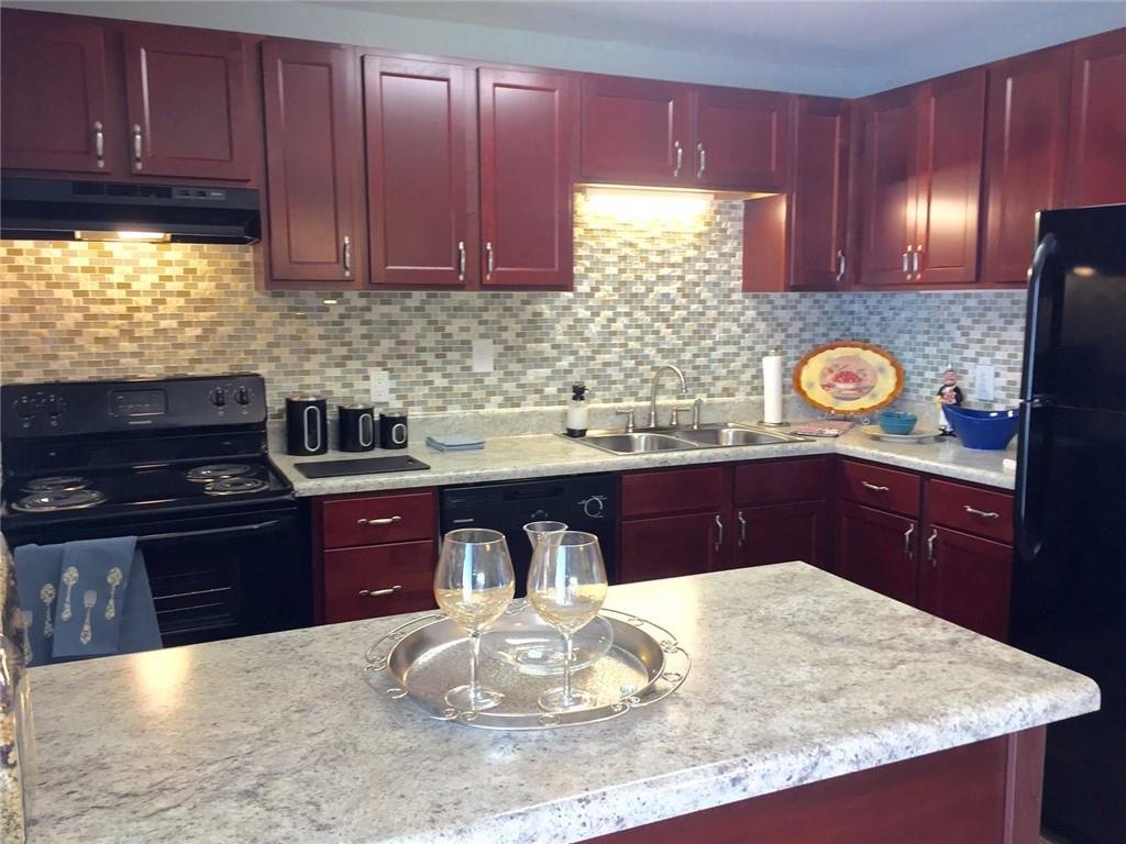 a kitchen with stainless steel appliances granite countertop wooden cabinets