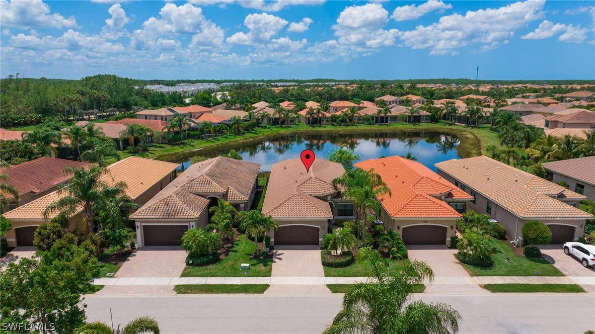 an aerial view of a house with a garden and lake view