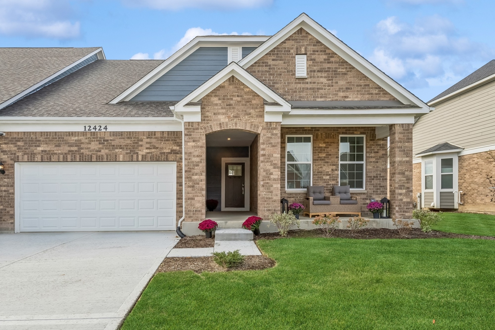 a front view of a house with a yard and garage