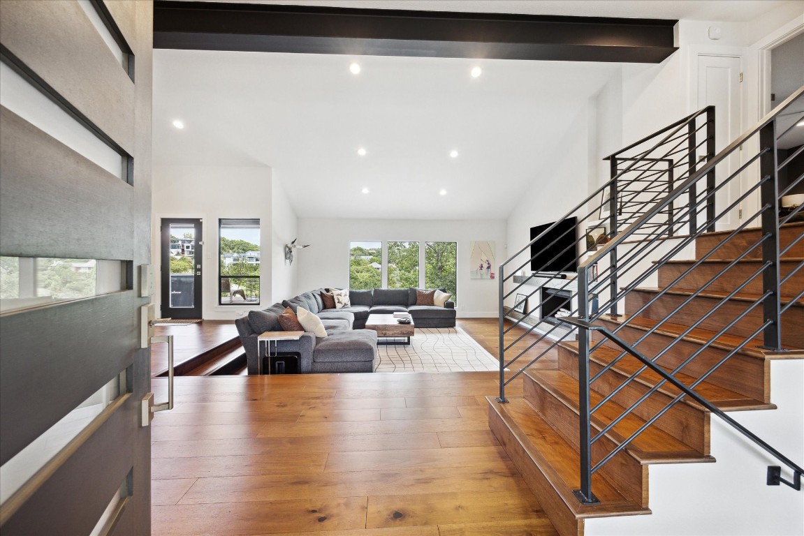 a living room with furniture or wooden floor and a large window