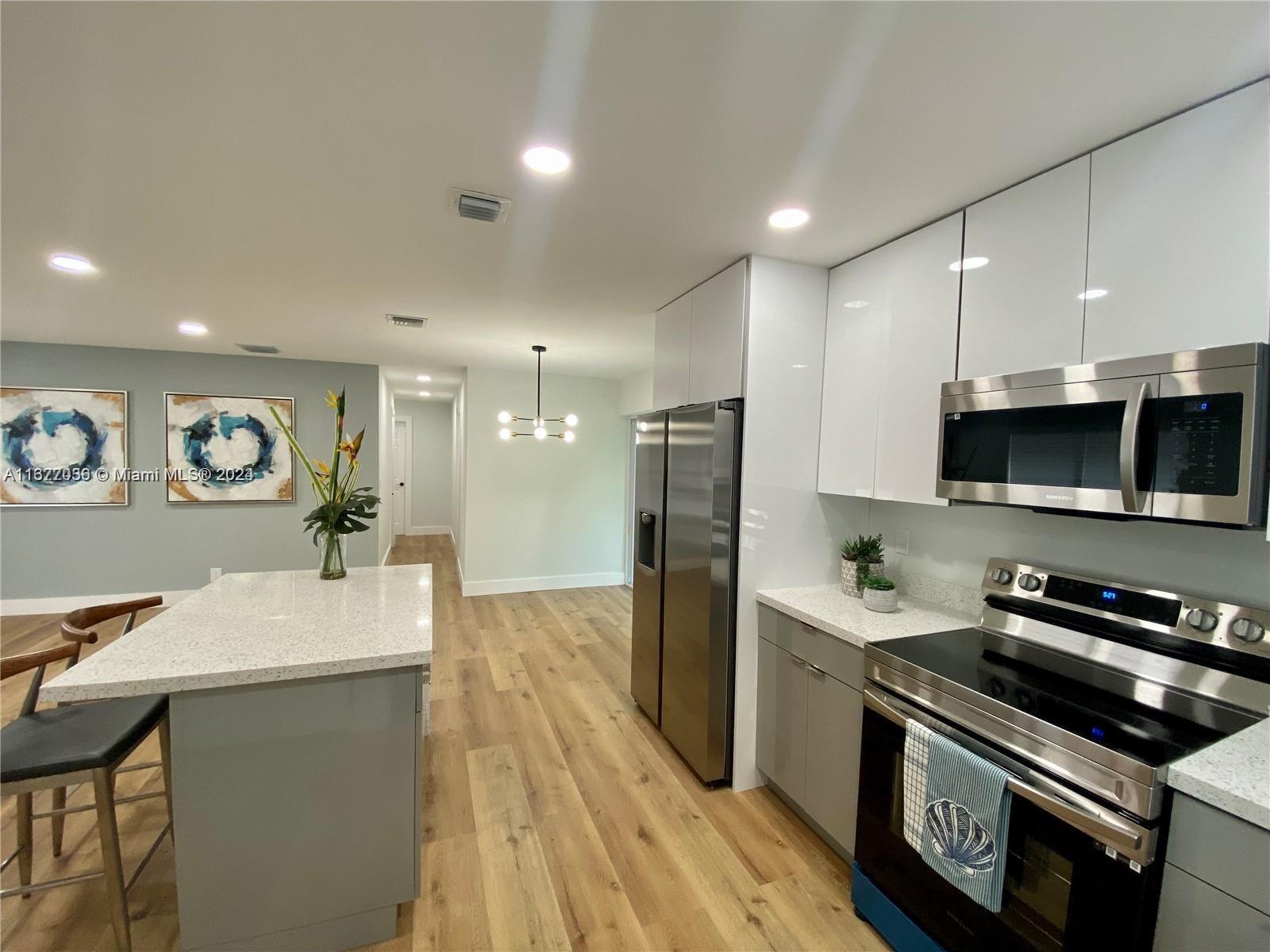 a kitchen with a sink stainless steel appliances and cabinets