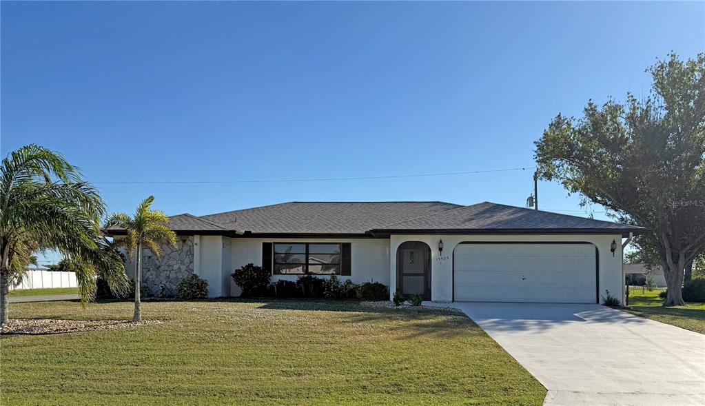 a front view of a house with a garden and yard