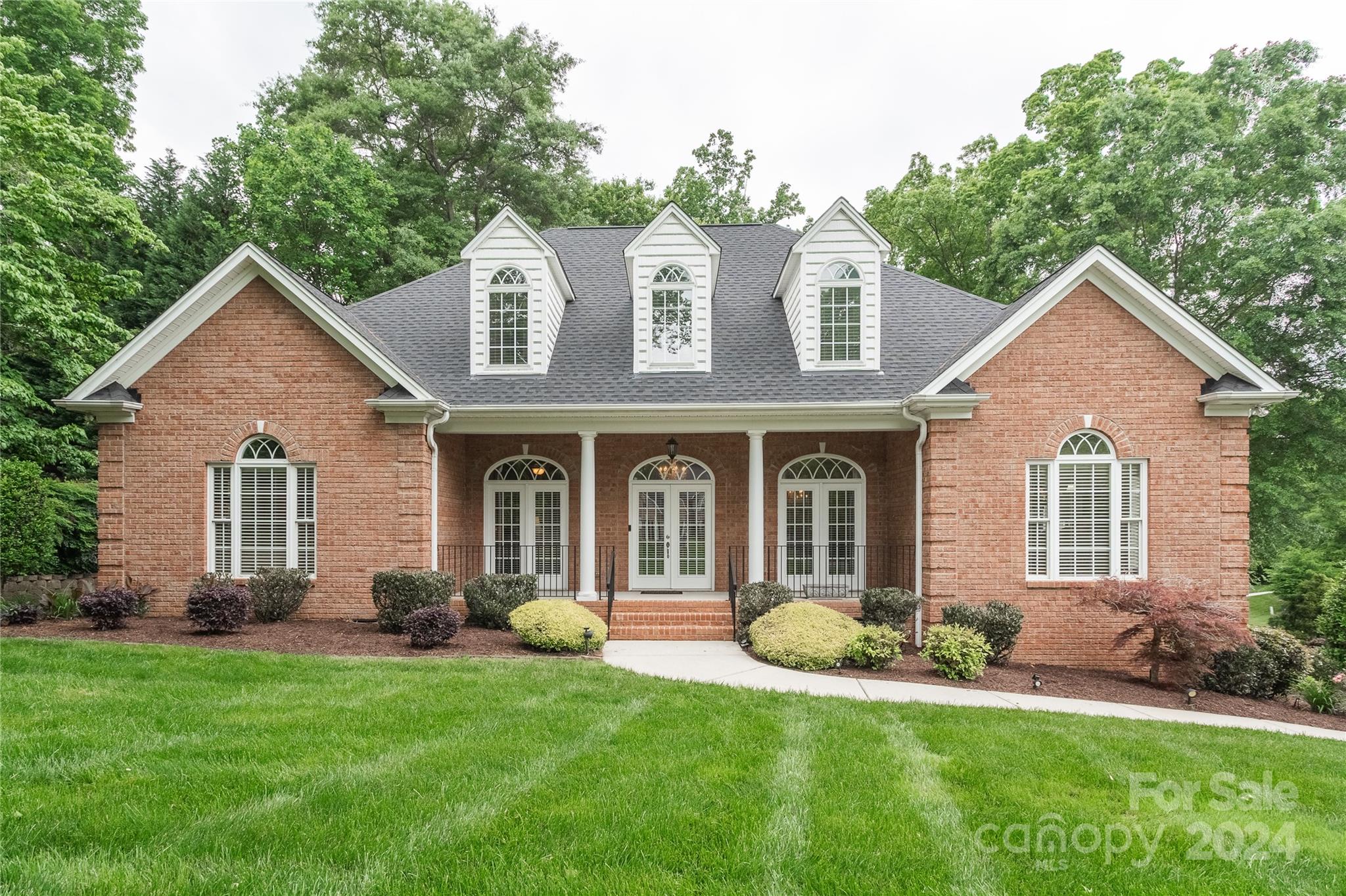 a front view of a house with a yard and porch