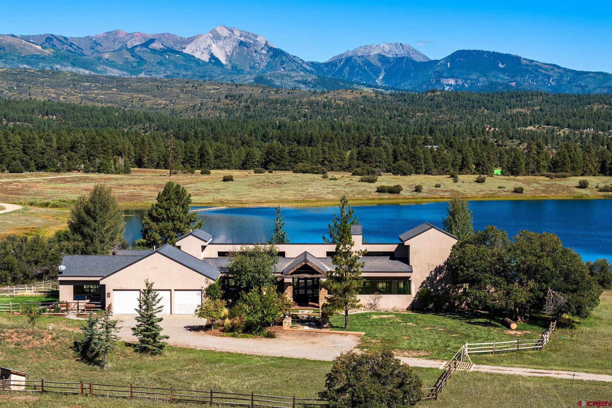 a view of house with swimming pool and mountains