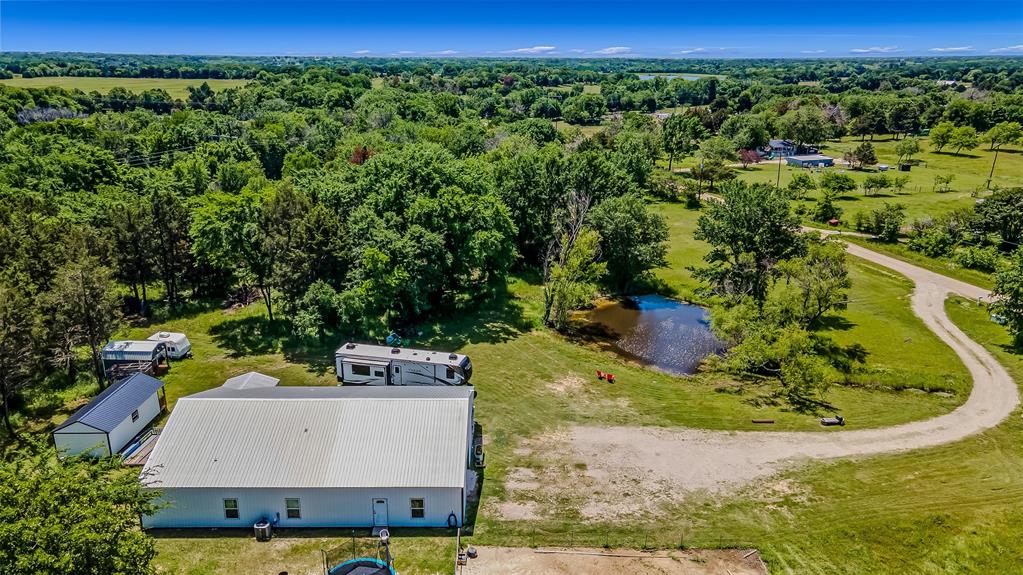 an aerial view of a house with a yard