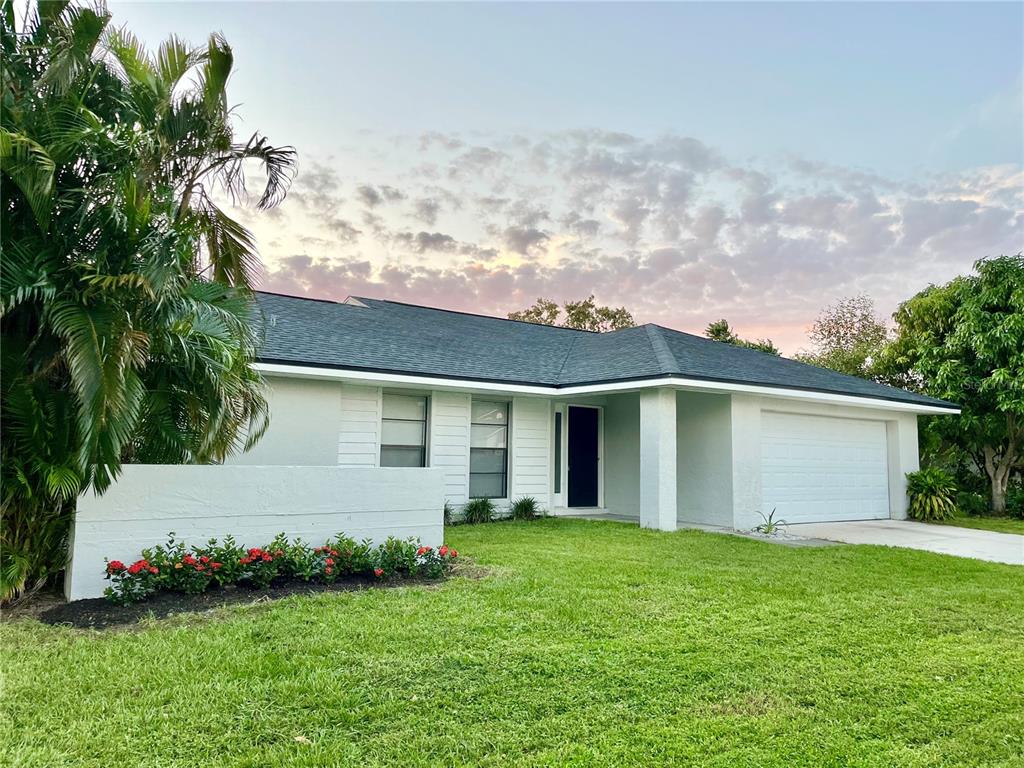 a view of backyard with garden and garage