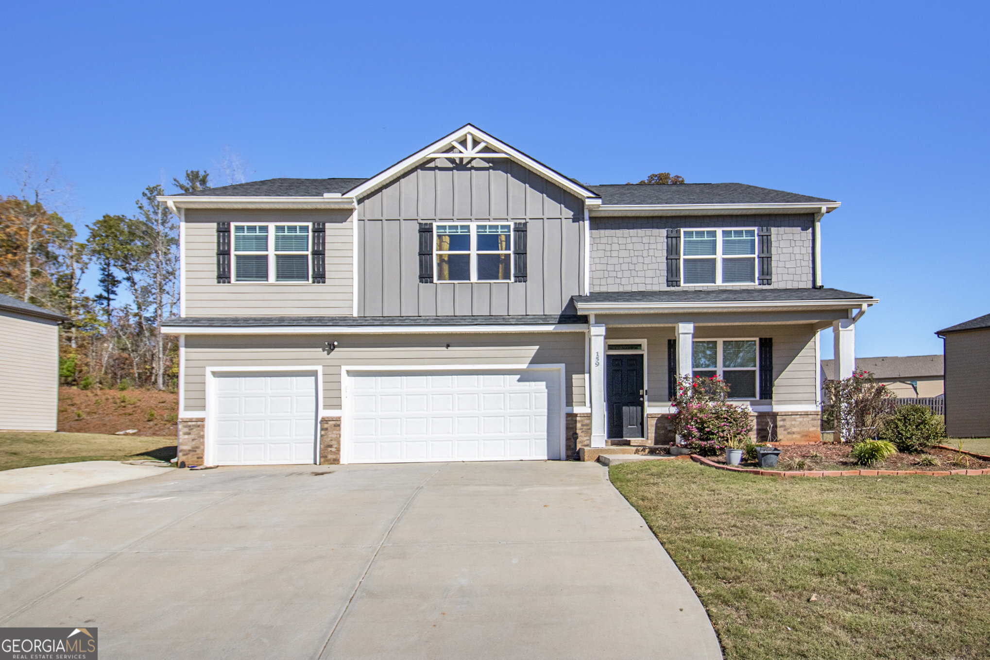 a front view of a house with a yard and garage