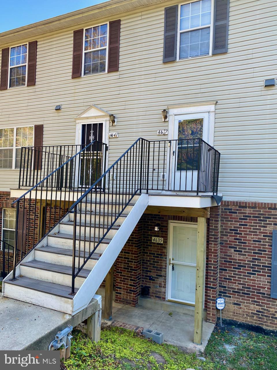 a view of front door of house with stairs